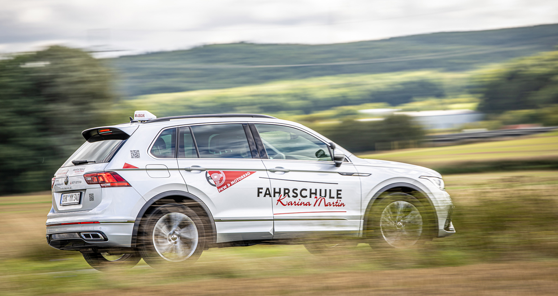 Gebrandetes weißes Auto der Fahrschule Martin auf der Landstraße